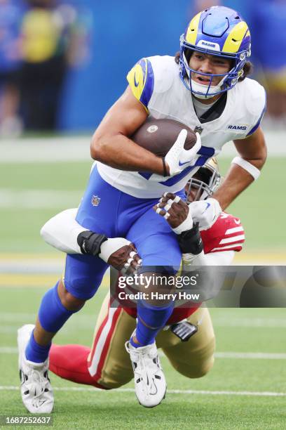 Puka Nacua of the Los Angeles Rams is tackled by Drake Jackson of the San Francisco 49ers during the first quarter at SoFi Stadium on September 17,...