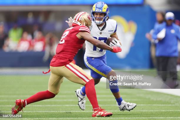 Puka Nacua of the Los Angeles Rams stiff arms Deommodore Lenoir of the San Francisco 49ers during the first quarter at SoFi Stadium on September 17,...