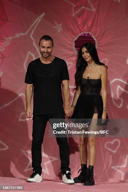 Designers Kristian and Hila Aadnevik walk the runway in the finale at the Aadnevik show during London Fashion Week September 2023 at the on September...