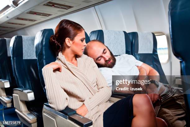 rude passenger on the airplane - irritatie stockfoto's en -beelden