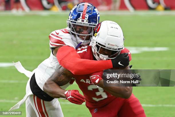 Emari Demercado of the Arizona Cardinals is tackled by Isaiah Simmons of the New York Giants during the second quarter at State Farm Stadium on...