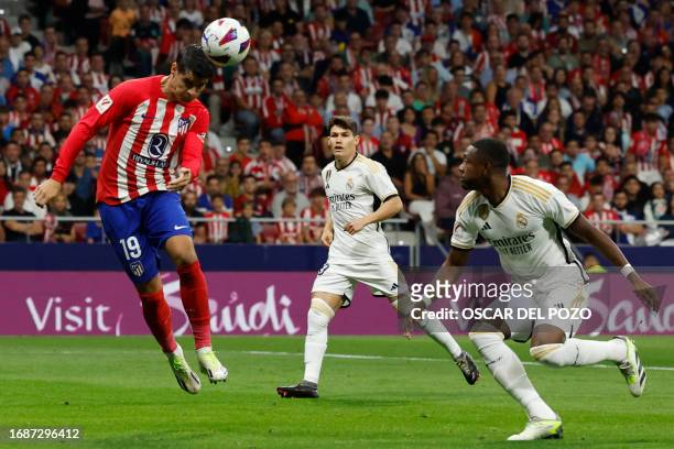 Atletico Madrid's Spanish forward Alvaro Morata scores the opening goal during the Spanish Liga football match between Club Atletico de Madrid and...