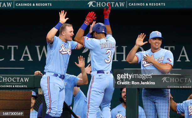 Leody Taveras of the Texas Rangers celebrates with teammate Josh Jung after hitting a two run home run against the Seattle Mariners during the fourth...