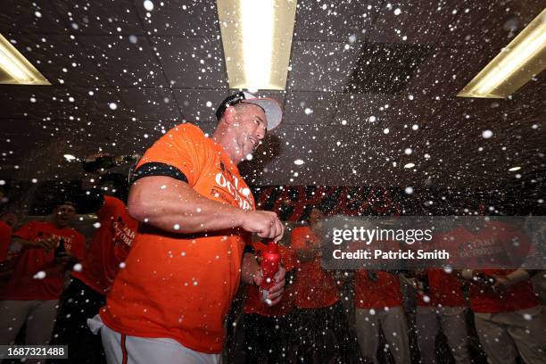 Manager Brandon Hyde of the Baltimore Orioles celebrates in the clubhouse after the Baltimore Orioles clinched a 2023 MLB playoff berth after...