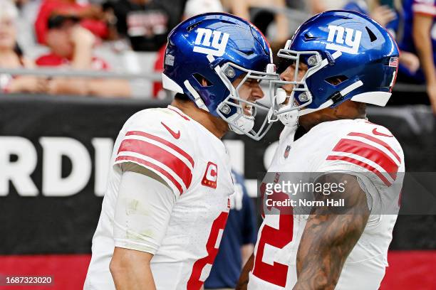 Daniel Jones of the New York Giants celebrates a touchdown with Darren Waller during the third quarter in the game against the Arizona Cardinals at...