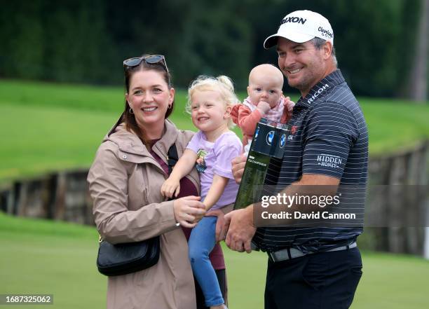 Ryan Fox of New Zealand holds the trophy with his wife Anneke Ryff and their two children after the final round of the BMW PGA Championship at...