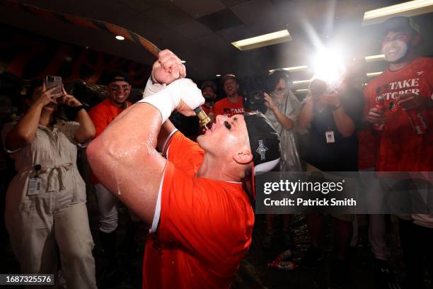 Ryan O'Hearn of the Baltimore Orioles drinks from the 'Homer Hose' as he and teammates celebrate in the clubhouse after the Baltimore Orioles...