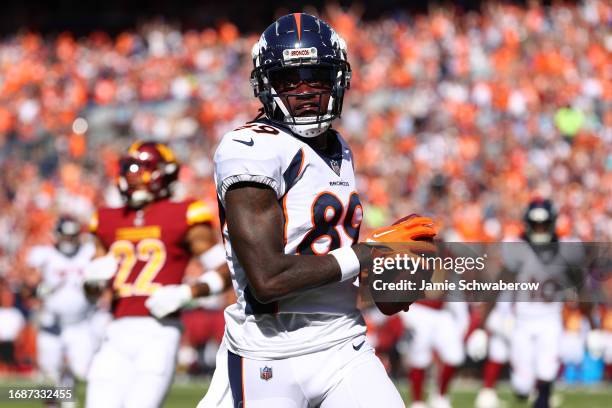 Brandon Johnson of the Denver Broncos scores a touchdown during the second quarter against the Washington Commanders at Empower Field At Mile High on...