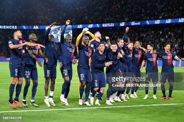 S players celebrate with supporters after winning the French L1 football match between Paris Saint-Germain and Olympique de Marseille at The Parc des...