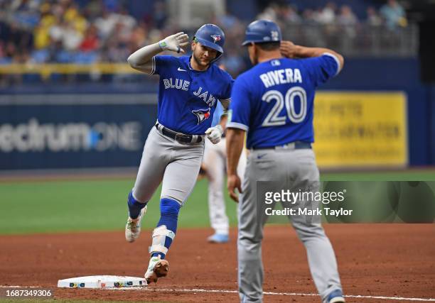 Toronto Blue Jays shortstop Bo Bichette celebrates with third base coach Luis Rivera after hitting a ninth inning home run agains the Tampa Bay Rays...