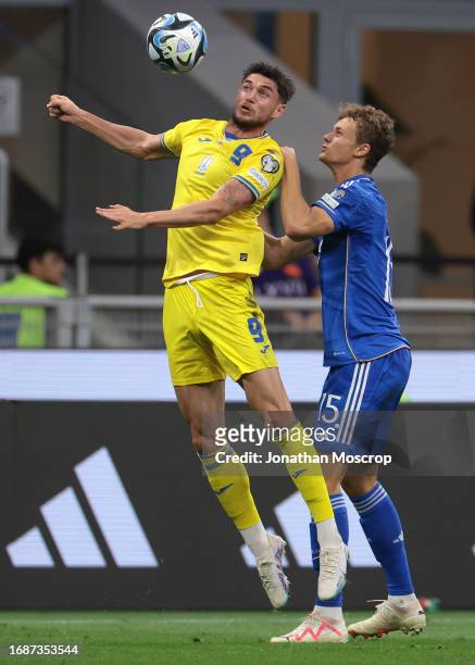 Roman Yaremchuk of Ukraine attempts to control an aerial ball under pressure from Giorgio Scalvini of Italy during the UEFA EURO 2024 European...