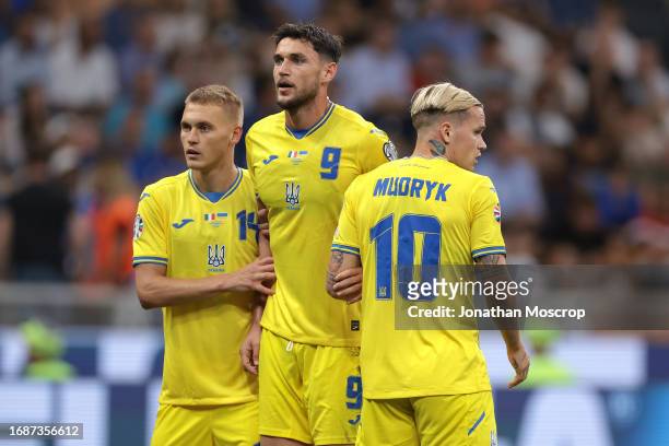 Vitaliy Buyalskyi, Roman Yaremchuk and Mykhailo Mudryk of Ukraine form a defensive wall during the UEFA EURO 2024 European qualifier match between...