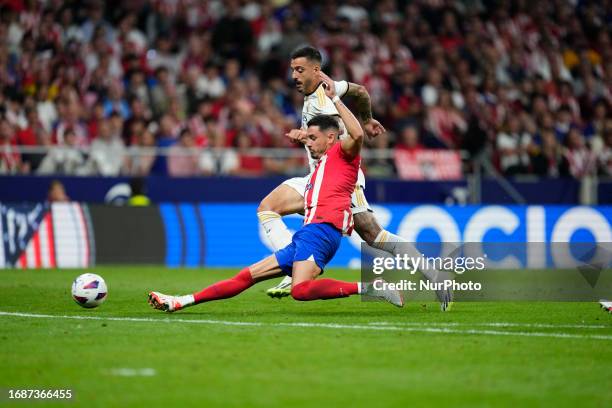 Joselu centre-forward of Real Madrid and Spain and Jose Maria Gimenez centre-back of Atletico de Madrid and Uruguay compete for the ball during the...