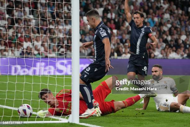 Ander Barrenetxea of Real Sociedad scores the first goal during the LaLiga EA Sports match between Real Madrid CF and Real Sociedad at Estadio...