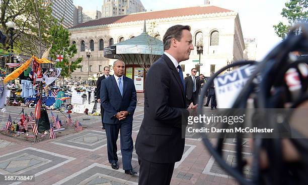 Prime Minister David Cameron and Massachusetts Governor Deval Patrick visit the memorial to the Boston Marathon bombing victims on Boylston Street on...