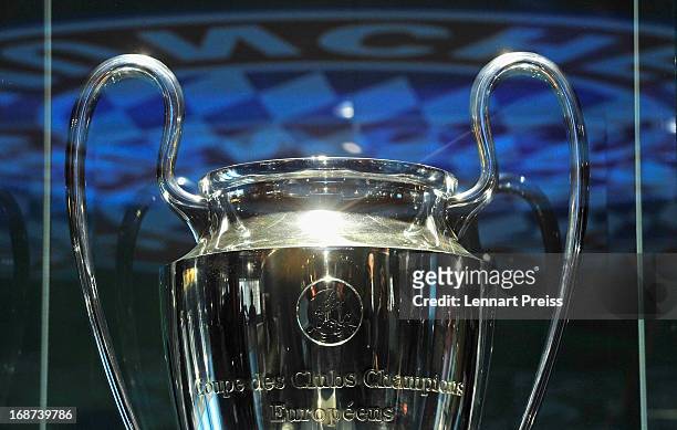 The logo of FC Bayern Muenchen is reflected in the showcase of the UEFA Champions League trophy in the FC Bayern Erlebniswelt during the UEFA...