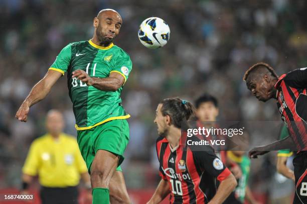 Frederic Kanoute of Beijing Guoan jumps to head the ball during the AFC Champions League Round of 16 match between Beijing Guoan and FC Seoul at...