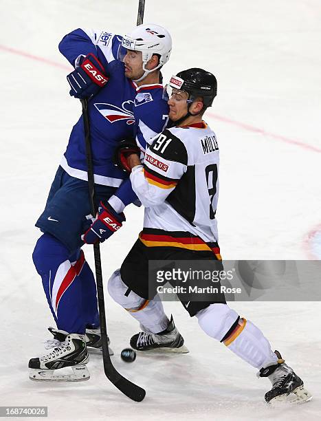 Sacha Treille of France and Moritz Mueller of Germany battle for the puck during the IIHF World Championship group H match between France and Germany...