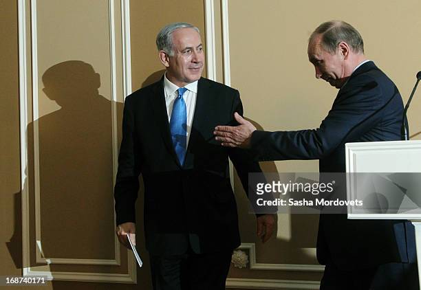 Russian President Vladimir Putin and Israeli Prime Minister Benjamin Netanyahu leave after holding a joint press conference at Bocharov Ruchei state...