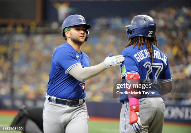 Bo Bichette of the Toronto Blue Jays is greeted at home by Vladimir Guerrero Jr. #27 after Bichette's ninth inning home run agains the Tampa Bay Rays...