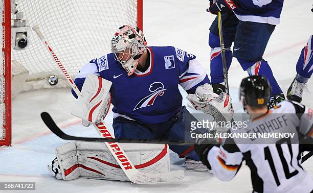 Germany's defender Christian Ehrhoff scores an overtime winning goal past French goalkeeper Cristobal Huet during a preliminary round game France vs...