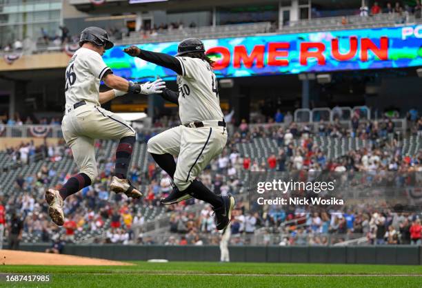 Max Kepler of the Minnesota Twins celebrates his two-run home run against the Los Angeles Angels during the seventh inning with Tommy Watkins at...
