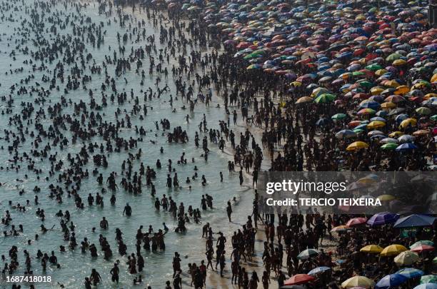 Sunbathers enjoy Macumba beach, in the west zone of Rio de Janeiro, on September 24 during a heat wave which registered 39.9 degrees.