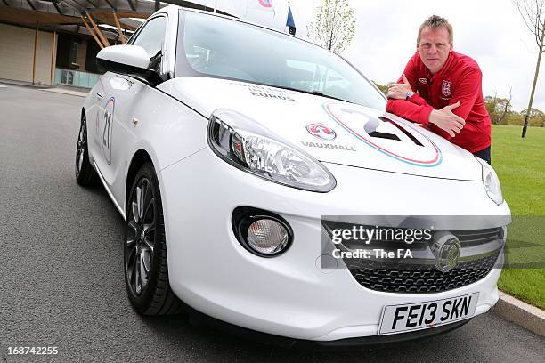 In this handout image provided by The FA, Stuart Pearce poses with a special Vauxhall Adam during the England Under 21 Squad Announcement for the...