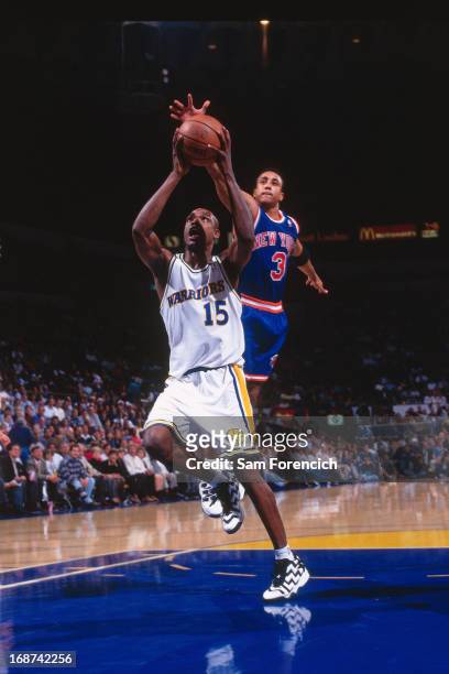 Latrell Sprewell of the Golden State Warriors shoots the ball against the New York Knicks circa 1996 at the Oakland-Alameda County Coliseum Arena in...
