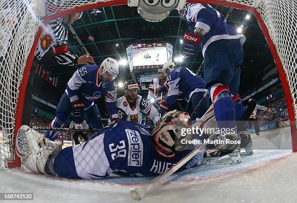 Cristobal Huet , goaltender of France covers the puck during the IIHF World Championship group H match between France and Germany at Hartwall Areena...