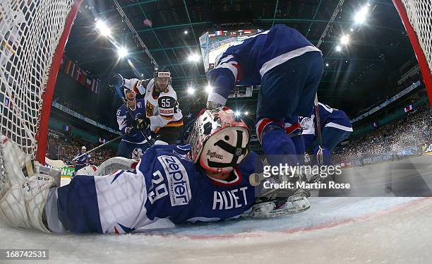 Cristobal Huet , goaltender of France makes a save on Felix Schuetz of Germany during the IIHF World Championship group H match between France and...