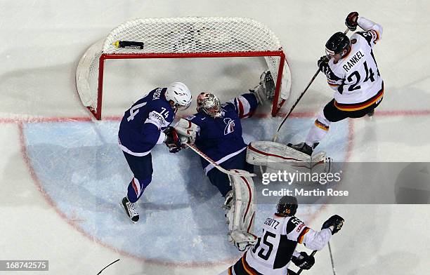 Cristobal Huet , goaltender of France covers the puck during the IIHF World Championship group H match between France and Germany at Hartwall Areena...