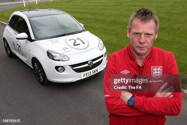 In this handout image provided by The FA, Stuart Pearce poses with a special Vauxhall Adam during the England Under 21 Squad Announcement for the...