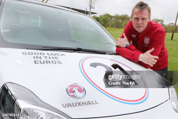 In this handout image provided by The FA, Stuart Pearce poses with a special Vauxhall Adam during the England Under 21 Squad Announcement for the...