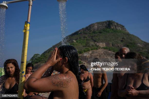Sunbathers enjoy Macumba beach, in the west zone of Rio de Janeiro, on September 24 during a heat wave which registered 39.9 degrees.