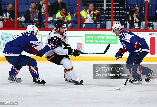 Sacha Treille of France and Justin Krueger of Germany battle for the puck during the IIHF World Championship group H match between France and Germany...