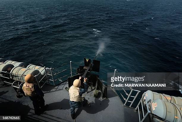 Navy personnel fires from his machinegun on a decoy target from USS Ponce, an Afloat Forward Staging Base , somewhere in the Arabian Sea, on May 14...