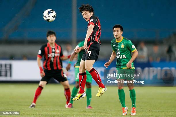 Kim Chi-Woo of Seoul FC heads the ball during the AFC Champions League Round of 16 match between Beijing Guoan and Seoul FC at Beijing Workers'...