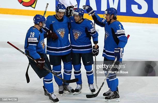 Sakari Salminen of Finland celebrate with his team mates after he scores his team's opening goal the IIHF World Championship group H match between...