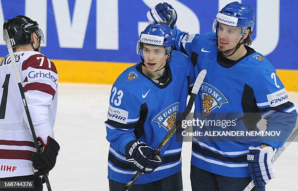 Finland's forward Sakari Salminen and Finland's defender Teemu Laakso celebrate scoring during a preliminary round game Latvia vs Finland of the IIHF...