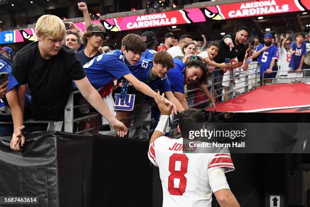 Daniel Jones of the New York Giants interacts with fans after a win over the Arizona Cardinals at State Farm Stadium on September 17, 2023 in...
