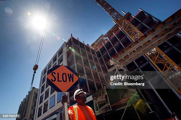 Contractor holds a "Slow" sign at the 279,000 square foot Tishman Speyer Properties LP Foundry Square III construction site on Howard Street in San...