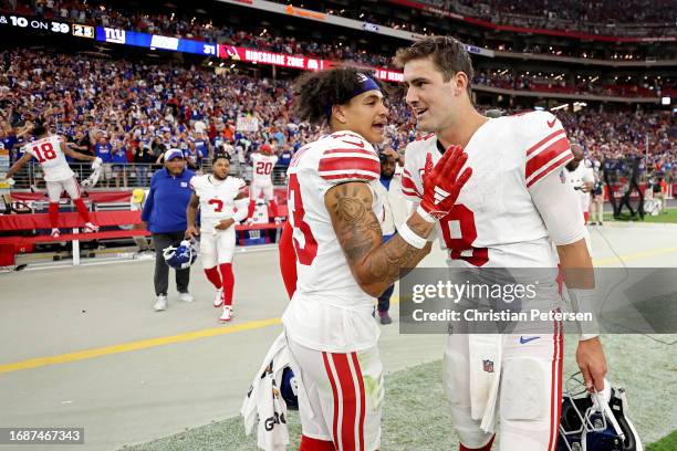 Jalin Hyatt of the New York Giants celebrates with Daniel Jones after a win over the Arizona Cardinals at State Farm Stadium on September 17, 2023 in...