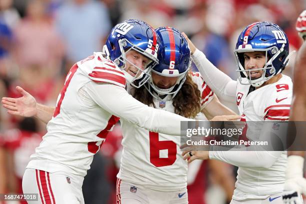 Casey Kreiter, Jamie Gillan and Graham Gano of the New York Giants celebrate a field goal during the fourth quarter in the game against the Arizona...