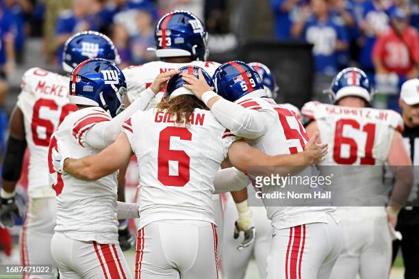 Casey Kreiter, Jamie Gillan and Graham Gano of the New York Giants celebrate a field goal during the fourth quarter in the game against the Arizona...