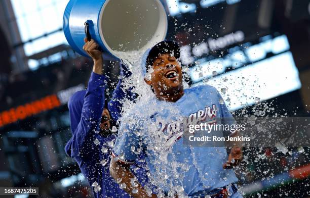 Jose Leclerc of the Texas Rangers is doused with ice water by teammate Martin Perez following the team's 9-8 win over the Seattle Mariners at Globe...