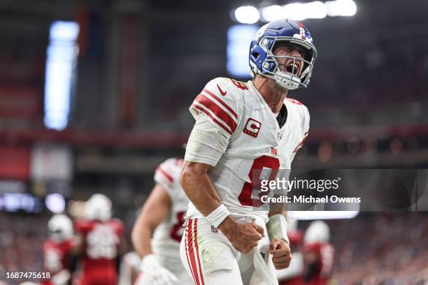 Daniel Jones of the New York Giants celebrates after running for a touchdown during the fourth quarter of an NFL football game between the Arizona...