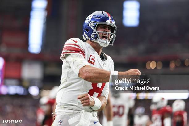 Daniel Jones of the New York Giants celebrates after running for a touchdown during the fourth quarter of an NFL football game between the Arizona...