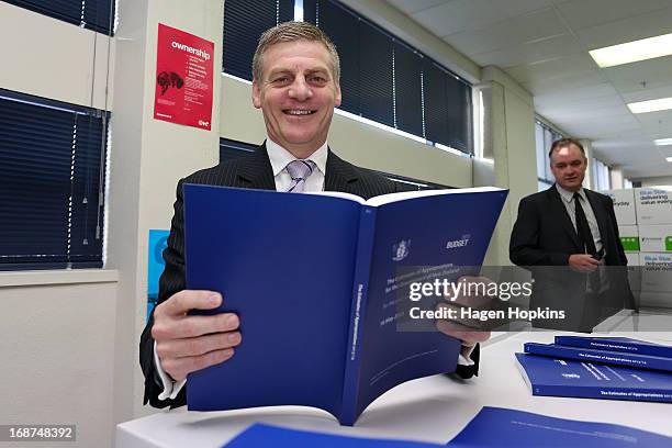 Finance Minister Bill English poses with a copy of the 2013 Estimates of Appropriations during the printing of the budget at Printlink on May 15,...