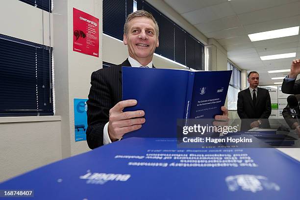 Finance Minister Bill English poses with a copy of the 2013 Estimates of Appropriations during the printing of the budget at Printlink on May 15,...